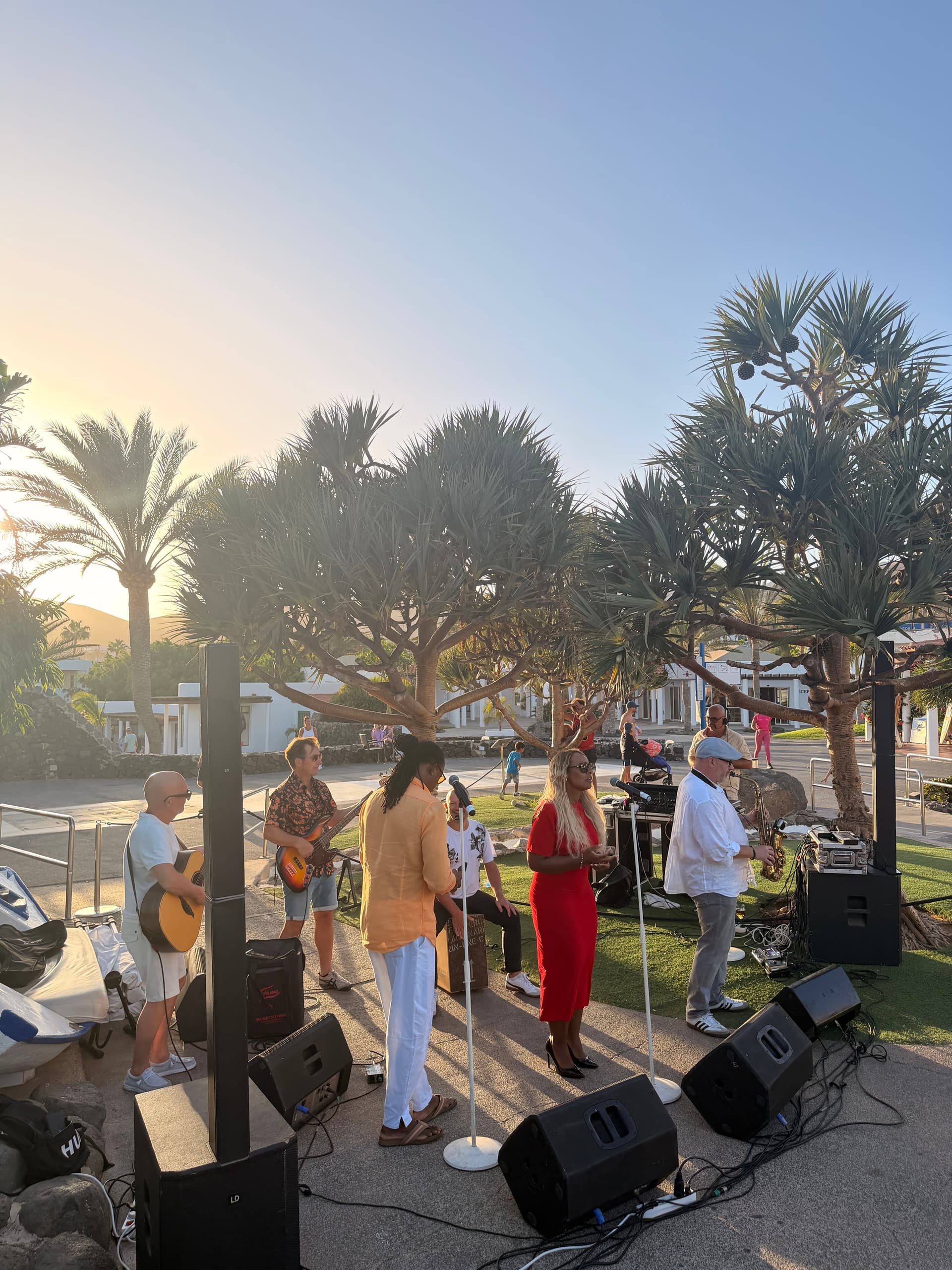 Band-Setup am Strand bei Sonnenuntergang mit Palmen